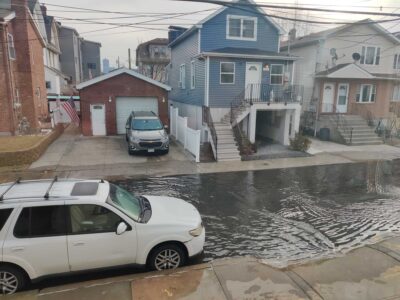 cars parked on the side of a road with houses on either side (MyCoast AI)