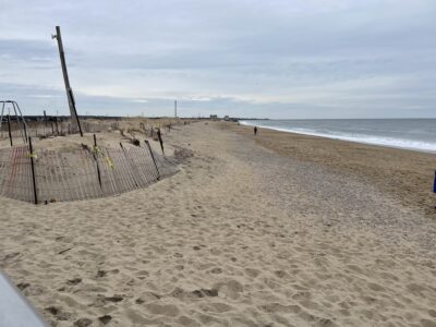 a sandy beach with a fence (MyCoast AI)