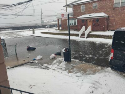 a street with trash cans and a car parked on the side (MyCoast AI)