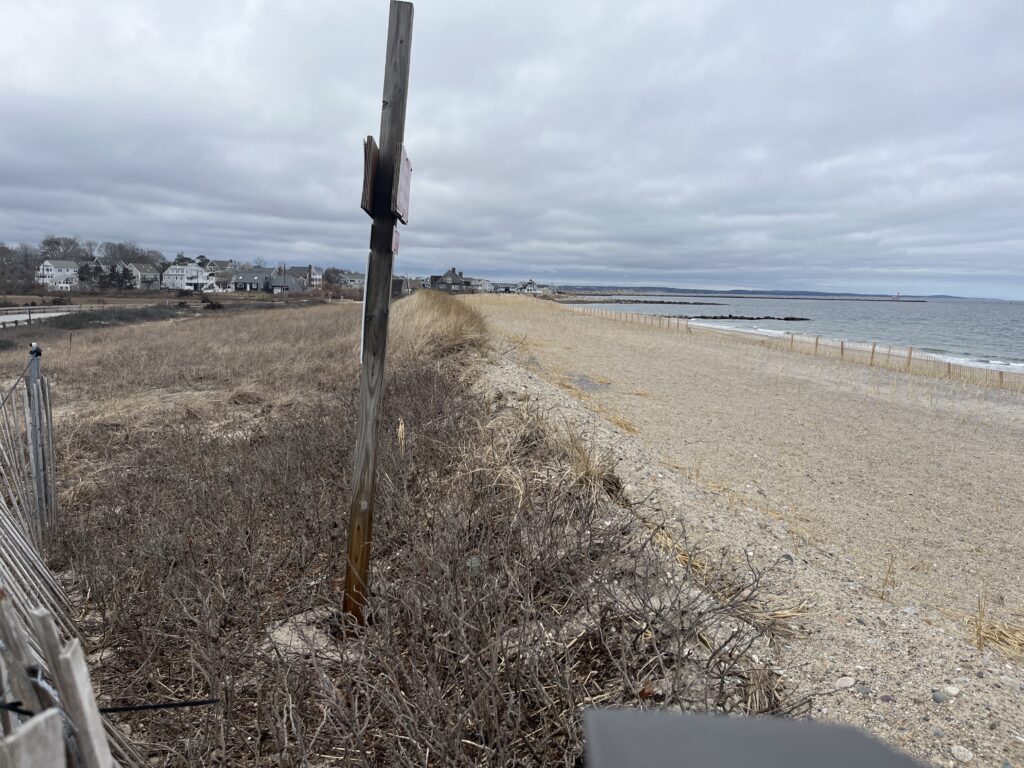 a sandy beach with a fence (MyCoast AI)