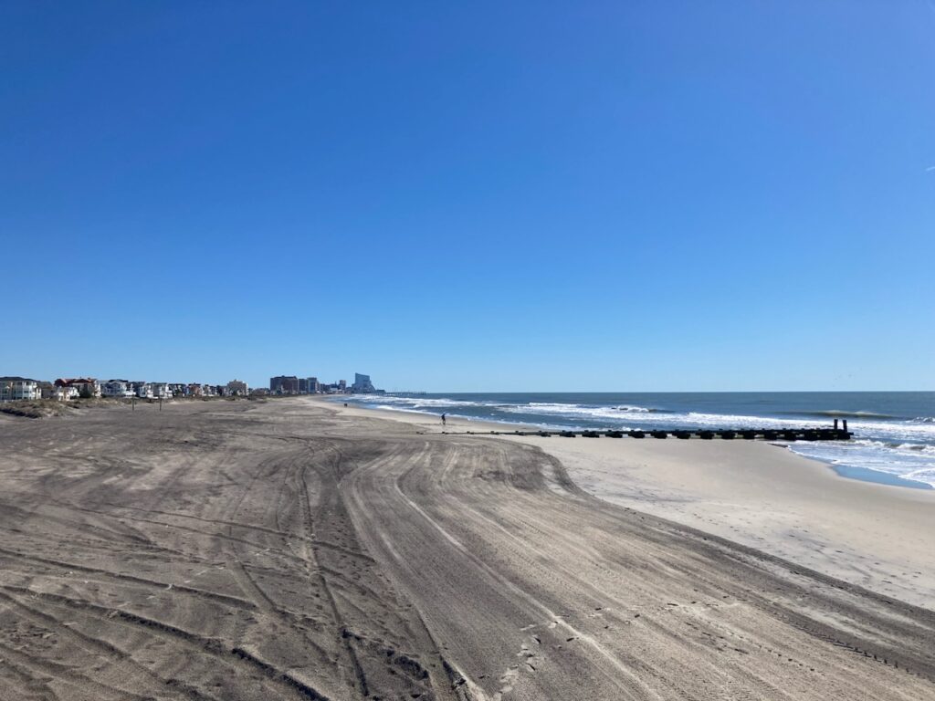 a sandy beach with waves crashing on it (MyCoast AI)