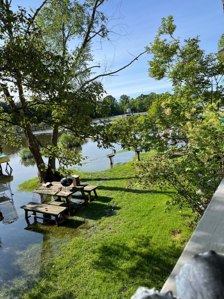 a picnic table and chairs by a lake (MyCoast AI)