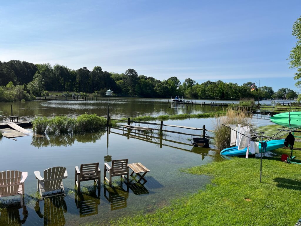 a body of water with chairs and tables by it (MyCoast AI)