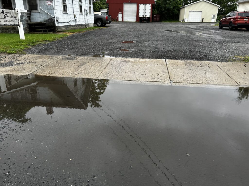a puddle on the street (MyCoast AI)
