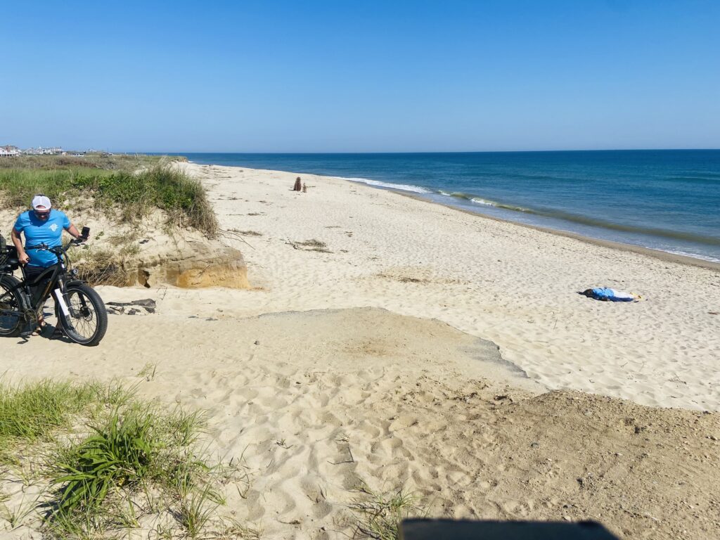 a person riding a bike on a beach (MyCoast AI)