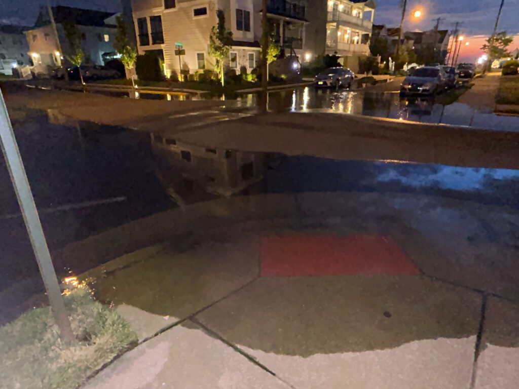 a puddle on the street (MyCoast AI)