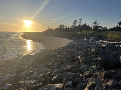 a rocky beach with the sun setting (MyCoast AI)