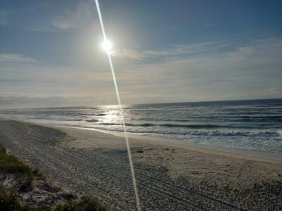 a beach with a trail of footprints (MyCoast AI)