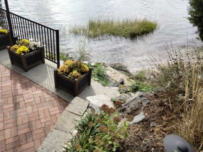 a patio with a railing and a body of water in the background (MyCoast AI)