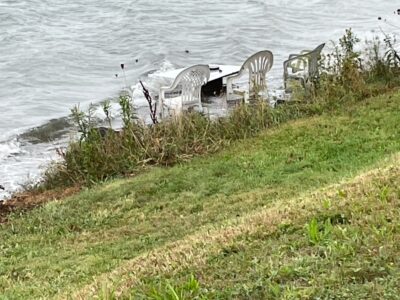 a group of chairs on a grassy hill by a body of water (MyCoast AI)