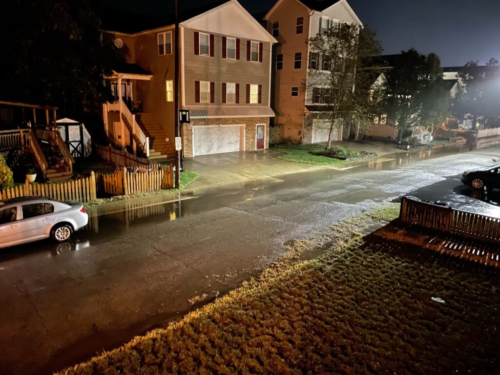 a street with a car parked on the side and a building on the other side (MyCoast AI)