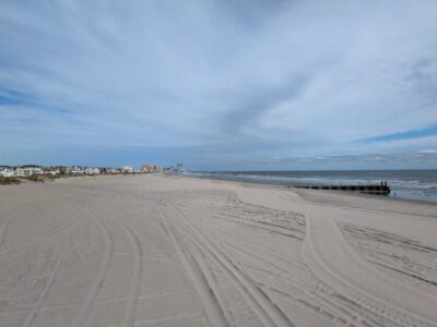 a sandy beach with buildings in the background (MyCoast AI)