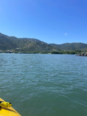 a body of water with boats and hills in the background (MyCoast AI)