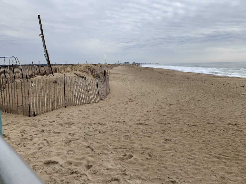 a sandy beach with a fence (MyCoast AI)