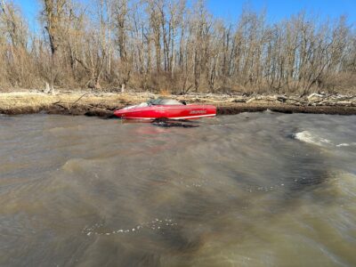 a red boat on a river (MyCoast AI)