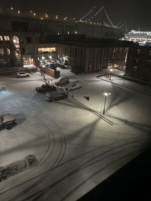 a parking lot with cars and a building in the background (MyCoast AI)