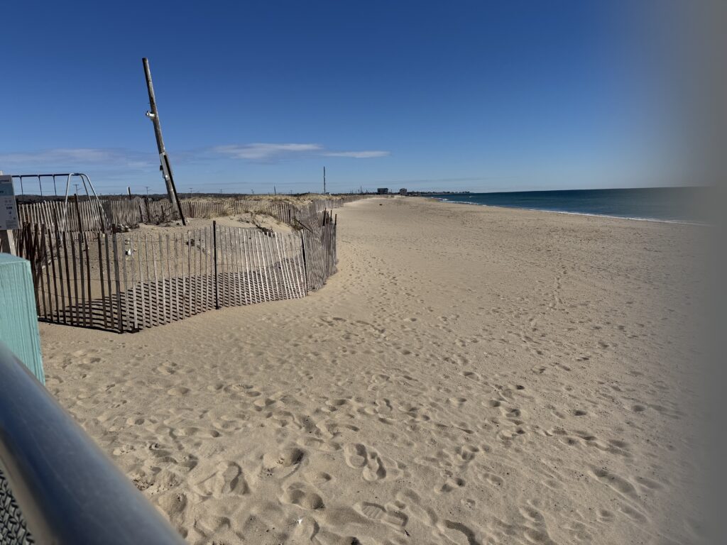 a sandy beach with a fence (MyCoast AI)