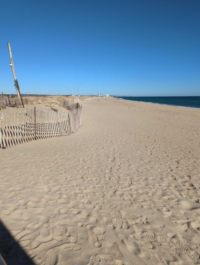 a sandy beach with a fence (MyCoast AI)