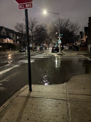 a street sign on a wet street (MyCoast AI)