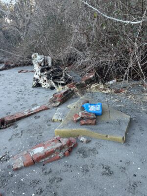 a pile of debris and a box on the ground (MyCoast AI)