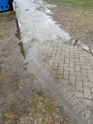 a puddle of water on a sidewalk (MyCoast AI)