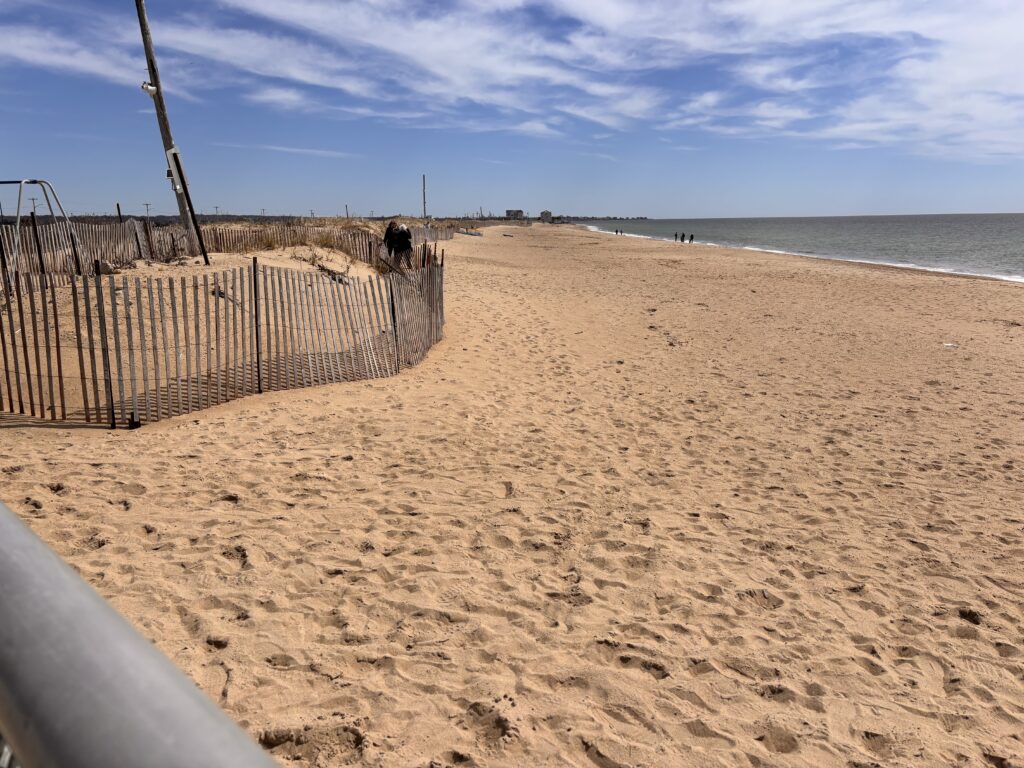 a sandy beach with a fence (MyCoast AI)