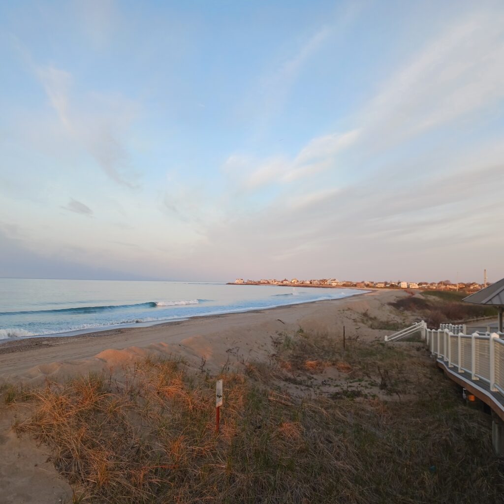 a beach with a fence and a body of water (MyCoast AI)
