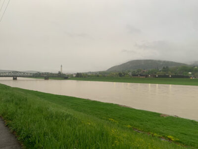 a body of water with grass and a bridge in the background (MyCoast AI)