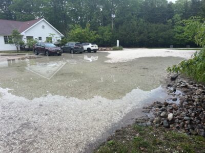 a flooded street with cars parked on the side (MyCoast AI)