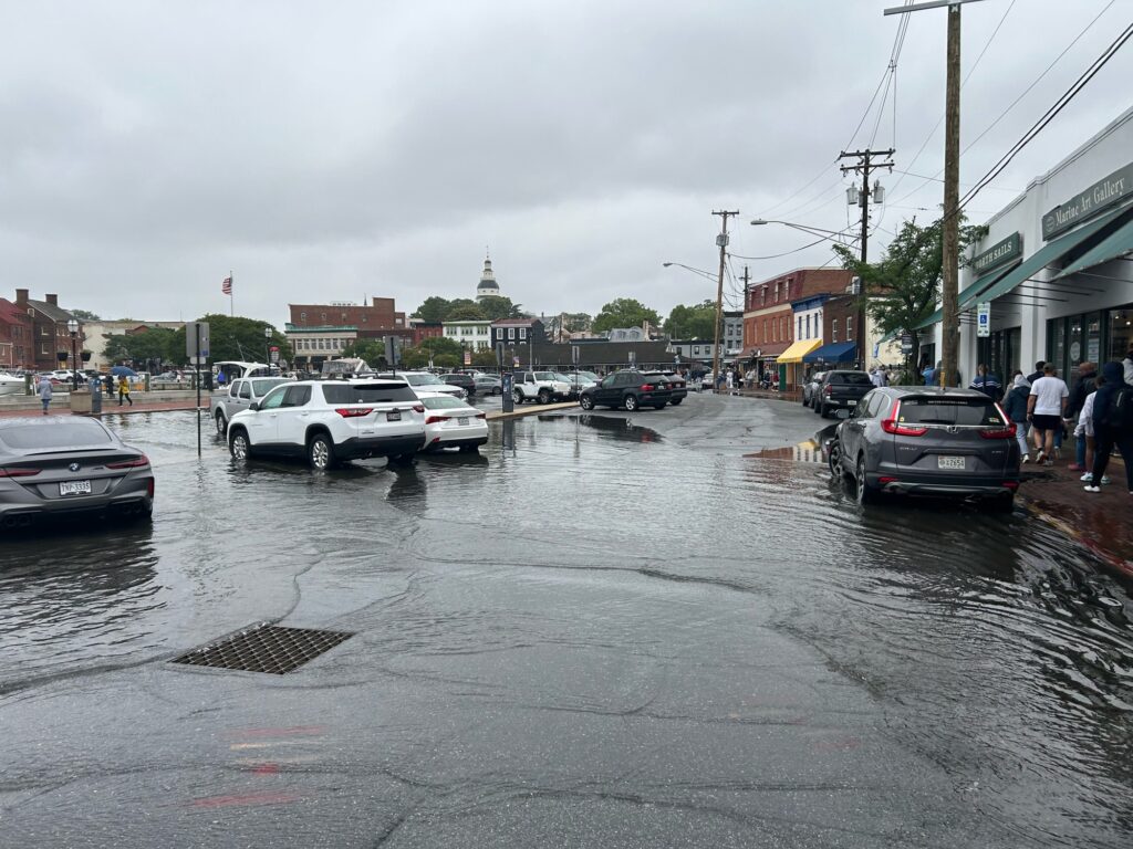 a flooded street with cars parked on the side (MyCoast AI)