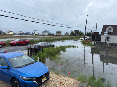 a flooded street with cars parked on the side (MyCoast AI)