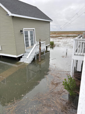 a flooded street with a house (MyCoast AI)
