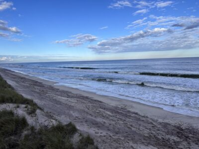 a beach with waves crashing on it (MyCoast AI)