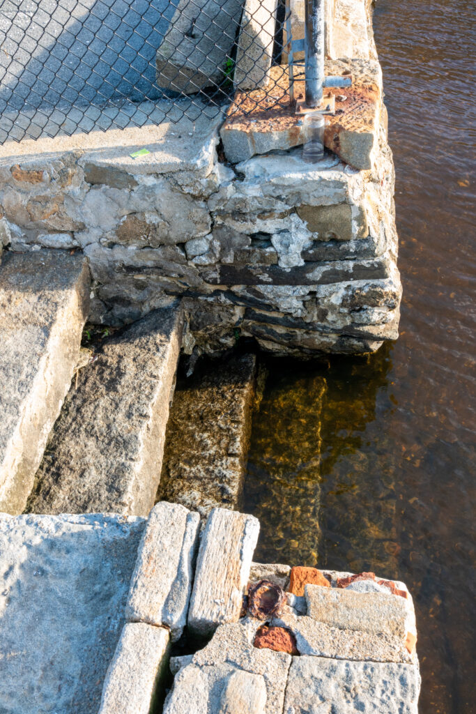 a stone wall with a water fountain (MyCoast AI)