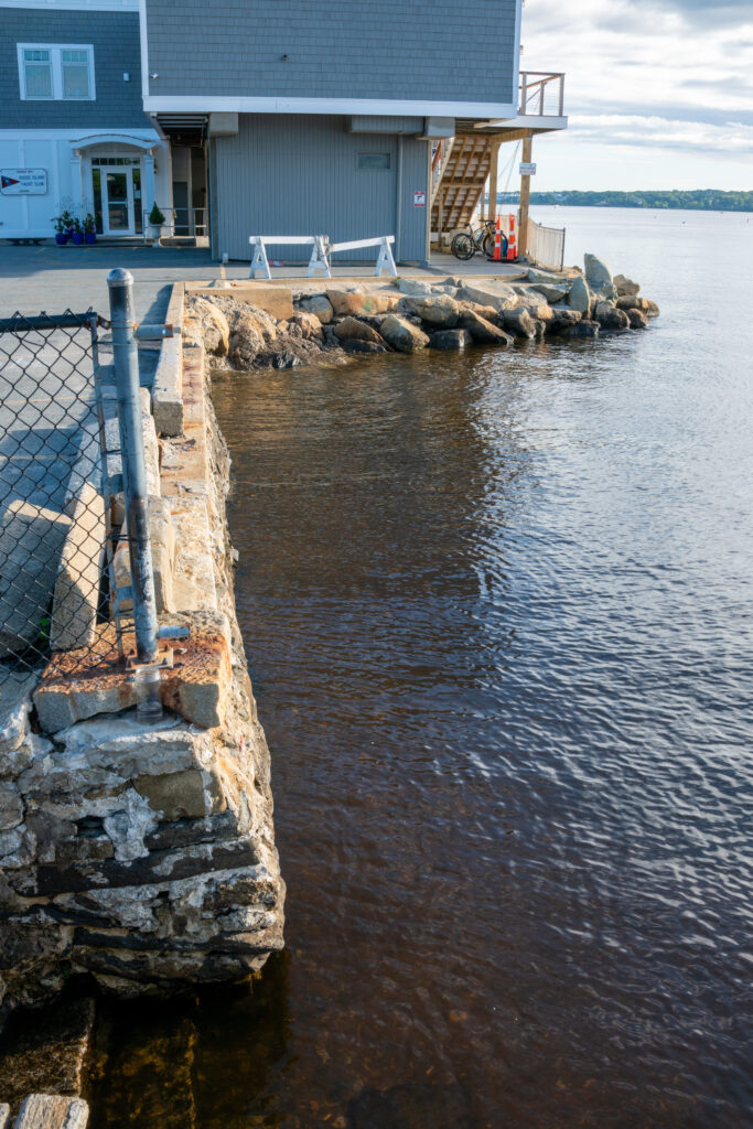 a building next to a body of water (MyCoast AI)