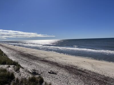 a sandy beach with waves crashing on it (MyCoast AI)