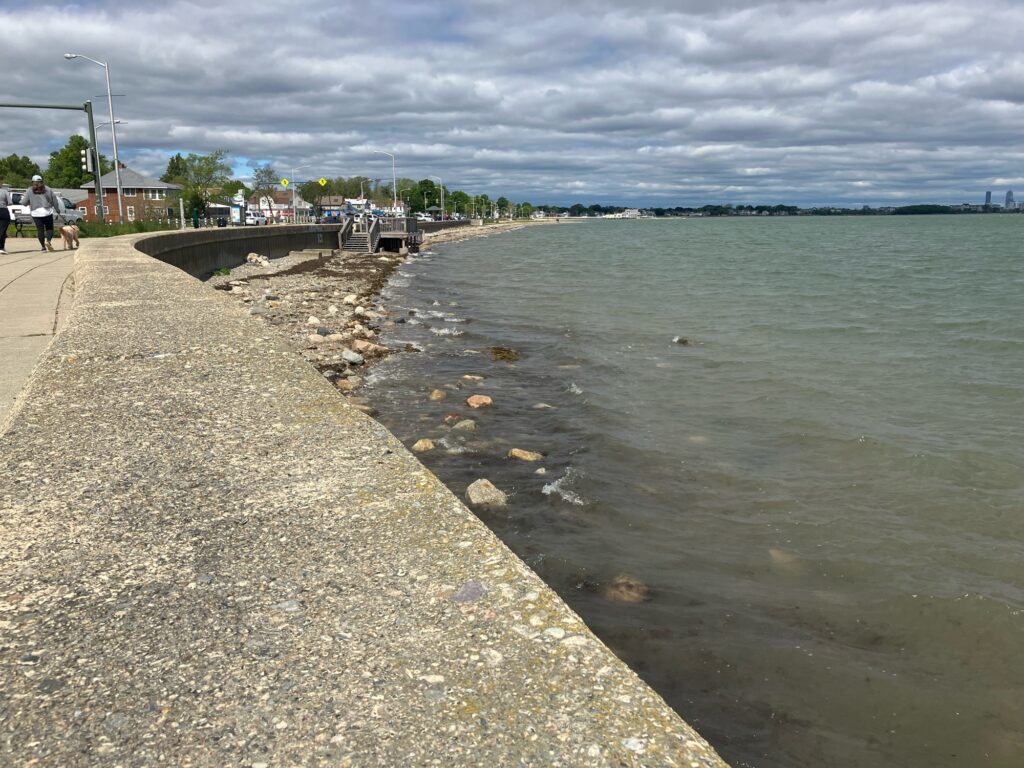 a body of water with a concrete wall and a sidewalk (MyCoast AI)