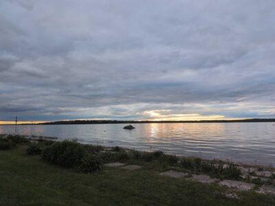 a body of water with grass and a land with a rock in it (MyCoast AI)