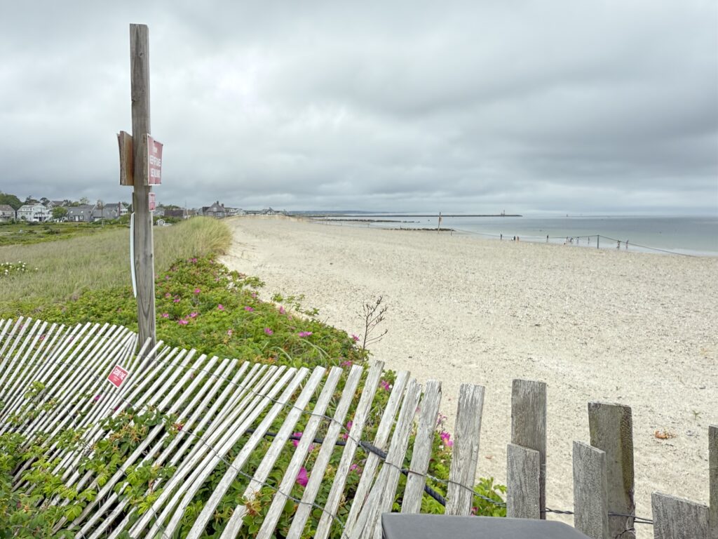 a beach with a fence and a sign (MyCoast AI)