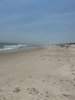 a sandy beach with people and water (MyCoast AI)