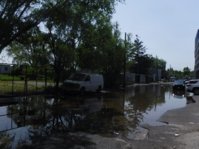 a flooded street with cars and trees (MyCoast AI)