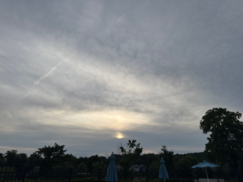 a group of umbrellas and chairs under a cloudy sky (MyCoast AI)