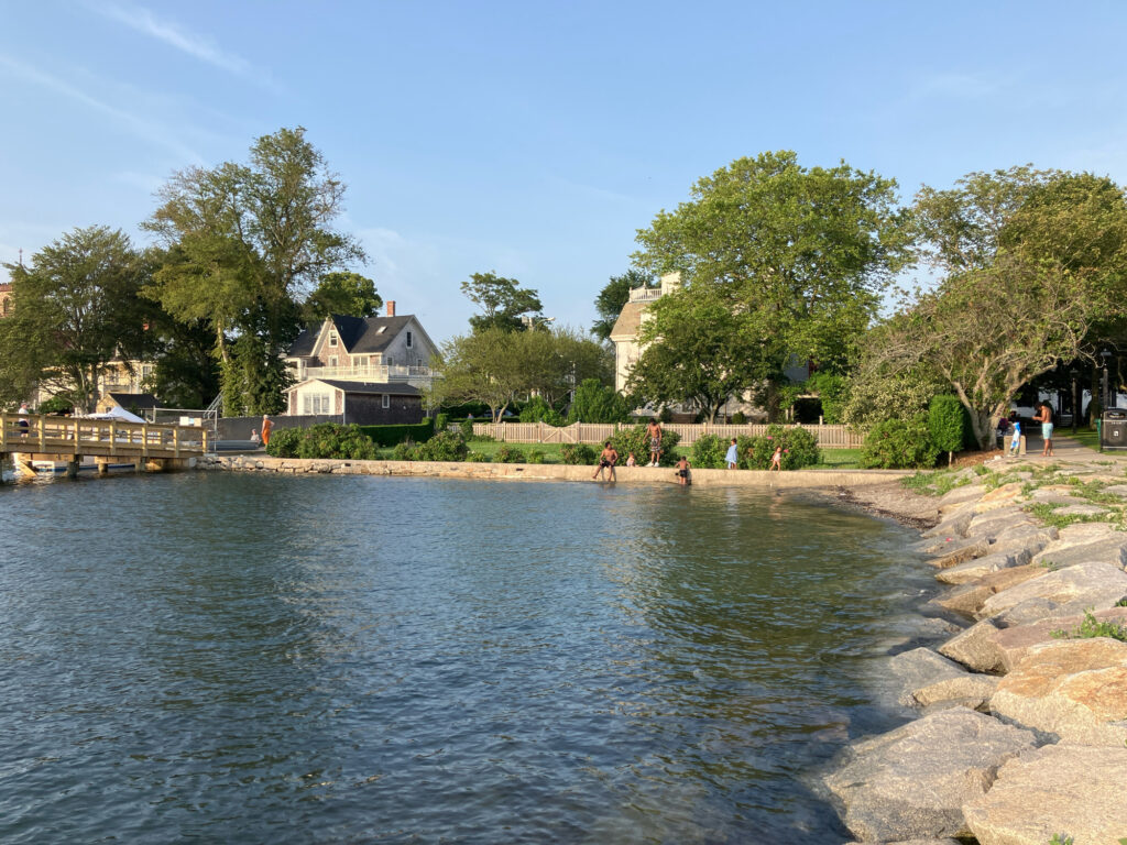 a body of water with people walking around it and trees around it (MyCoast AI)