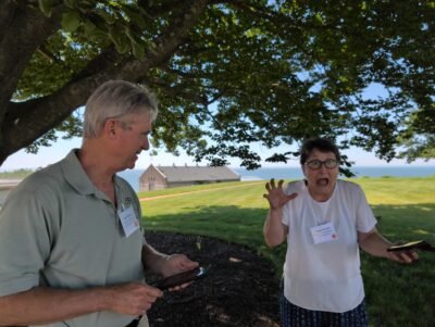 a man and a boy looking at a cell phone (MyCoast AI)
