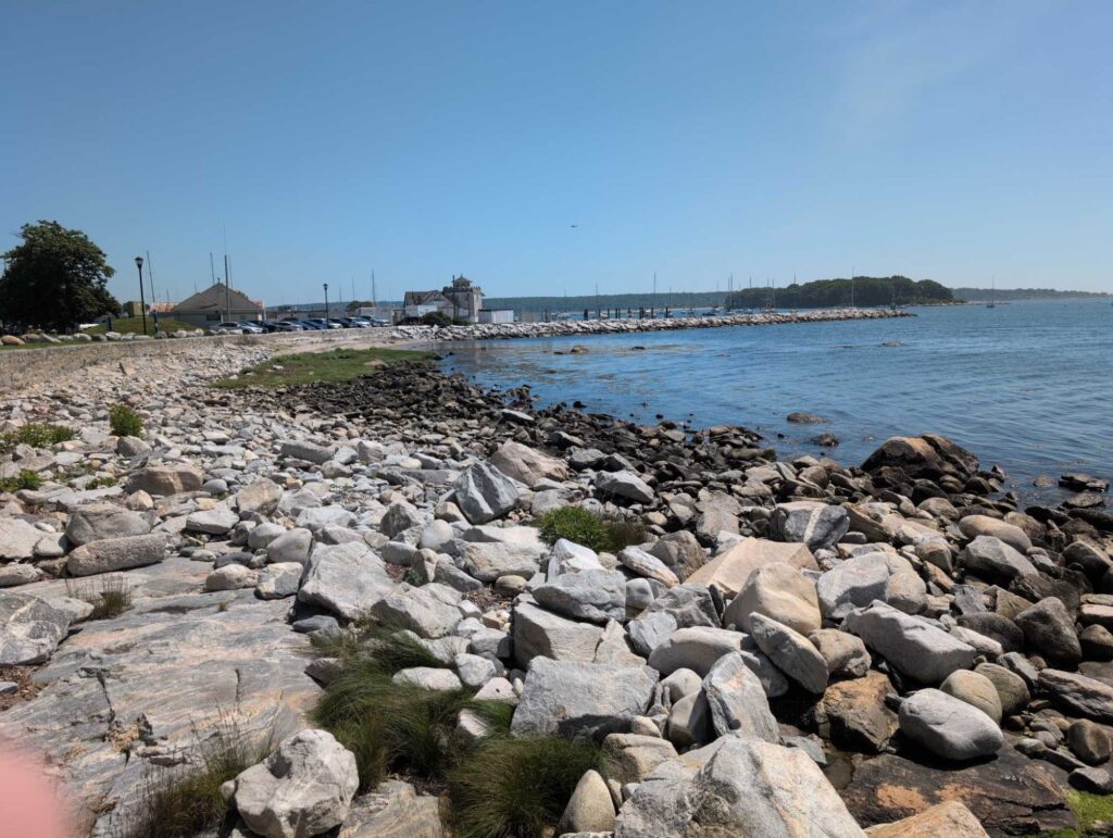 a rocky beach with a body of water in the background (MyCoast AI)