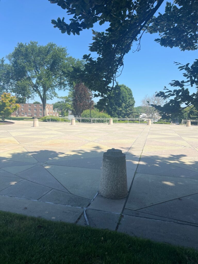 a concrete area with trees and grass (MyCoast AI)