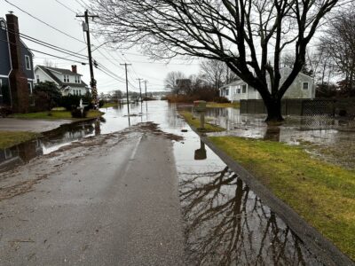 a flooded street with houses and trees (MyCoast AI)