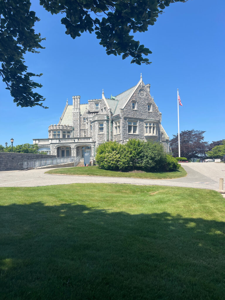 a large stone building with a flag on top (MyCoast AI)