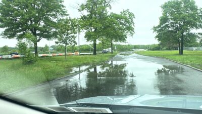 a flooded road with trees and grass (MyCoast AI)