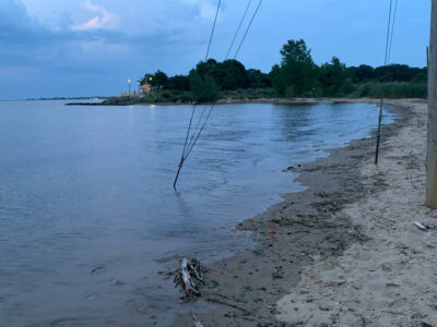 a beach with a net and trees (MyCoast AI)
